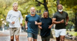 A group of older men running in the park